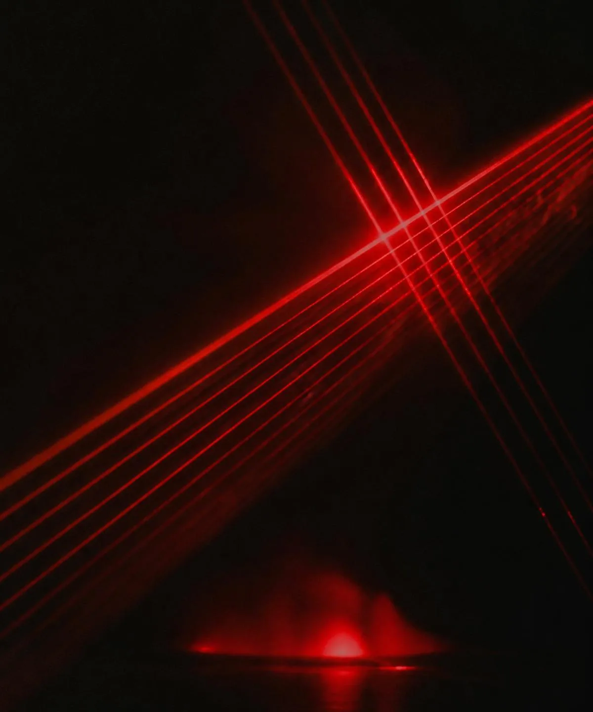 Red laser beams crossing a dark field